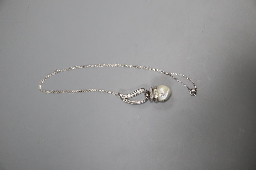 A modern 14k white metal, baroque pearl and diamond set drop pendant, on 750 white metal chain, pendant, 43mm, gross 8.5 grams.